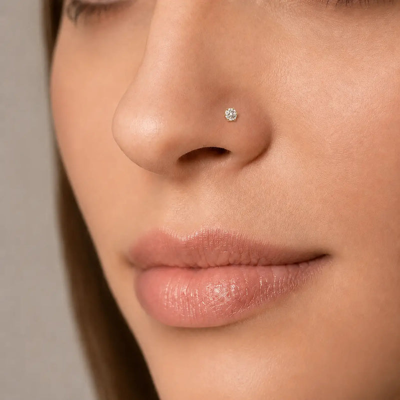 Close-up of an woman's nose wearing Astra 6-prong 3.5mm diamond nose stud earring.