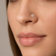 Close-up of an woman's nose wearing Astra 6-prong 4mm diamond nose stud earring.