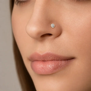 Close-up of an woman's nose wearing Astra 6-prong 4mm diamond nose stud earring.