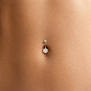 Close-up of the Astra moonstone belly button ring on a model's navel piercing