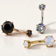Three genuine gemstone Astra belly buttons rings on a white background