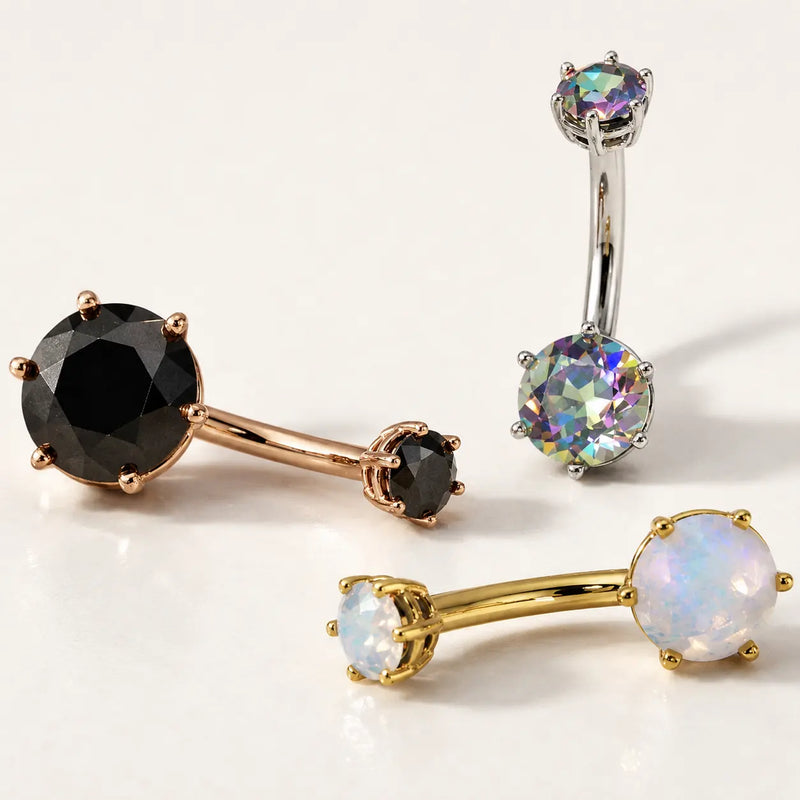 Three genuine gemstone Astra belly buttons rings on a white background