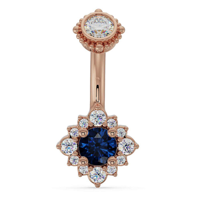 14k rose gold belly ring with blue sapphire center stone set in diamond halo flower design, front view