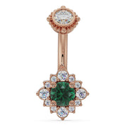 14k rose gold halo navel ring with emerald center stone and diamond flower surround, front view
