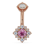 14k rose gold belly ring with pink sapphire center stone in diamond halo flower setting, front view