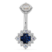 14k white gold belly ring with blue sapphire center stone surrounded by diamond halo flower setting
