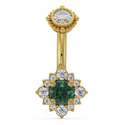 14k yellow gold halo navel ring with emerald center stone surrounded by diamond flower halo