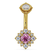 14k yellow gold belly ring with pink sapphire center and diamond halo, front view on white background