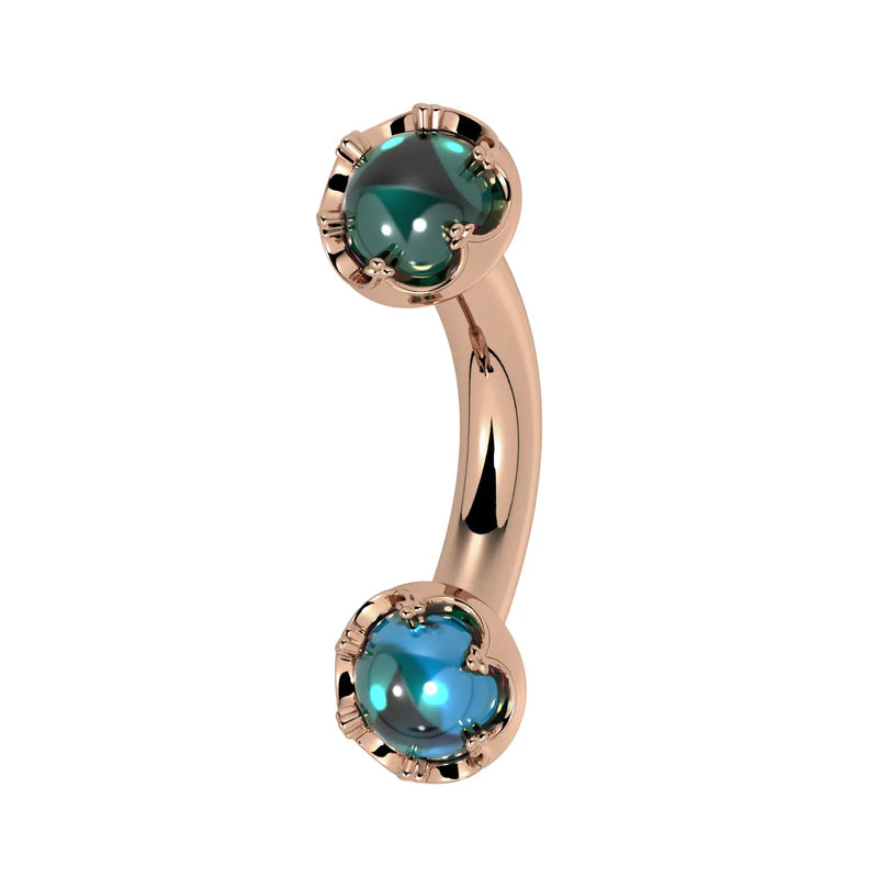 Reina London Blue Topaz Crown Curved Barbell in 14k rose gold, side view - for navel, rook, or eyebrow piercings