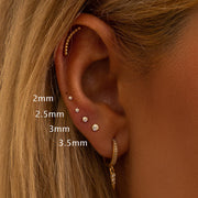 Diamond spike charm on gold hoop shown in ear stack with multiple piercings, size reference 2mm–3.5mm