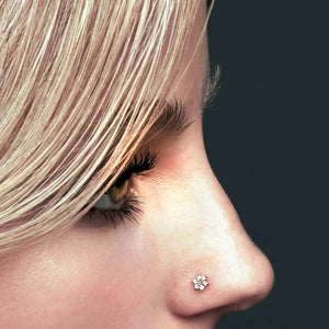 Clear CZ flower 14K gold nose ring twist shown in pierced nostril, close side profile on model