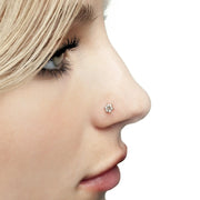 Clear CZ flower 14K gold nose ring twist worn in pierced nostril, side profile model shot for fit