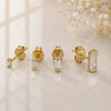 14K yellow gold baguette diamond stud earrings in four sizes displayed on marble surface