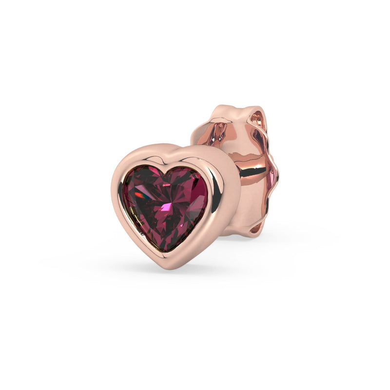 Single 14k rose gold rhodolite garnet heart stud earring, angled view with raspberry stone in rose bezel