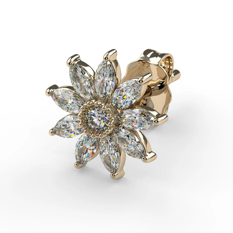 Gold flower-shaped earring with diamonds on a white background