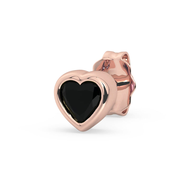 Single 14k rose gold onyx heart stud earring, angled view with black stone contrasting warm pink gold