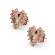 Pair of 14k rose gold radiant heart stud earrings displayed as matched set with spiked sunburst heart design