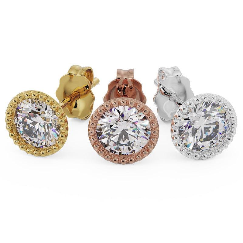 Three 14K gold milgrain stud earrings in yellow, rose, and white gold displayed front-facing with push backs