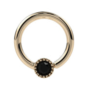 Close-up front view of 14k yellow gold Perlagé fixed bead ring highlighting the black diamond setting detail