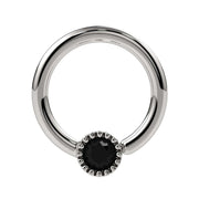 14k white gold black diamond Perlagé fixed bead ring, slightly angled front view emphasizing milgrain bezel contrast