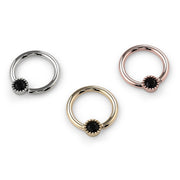 All three 14k gold color options of the black diamond Perlagé fixed bead ring shown from a slightly elevated angle