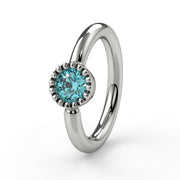 14k white gold aqua diamond Perlagé captive ring, close-up angled view highlighting milgrain setting