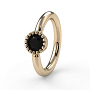 14k yellow gold black diamond fixed bead ring showing larger milgrain bezel detail, front angle view