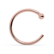 14K rose gold nose hoop with ball end, warm blush tone, front view on white background