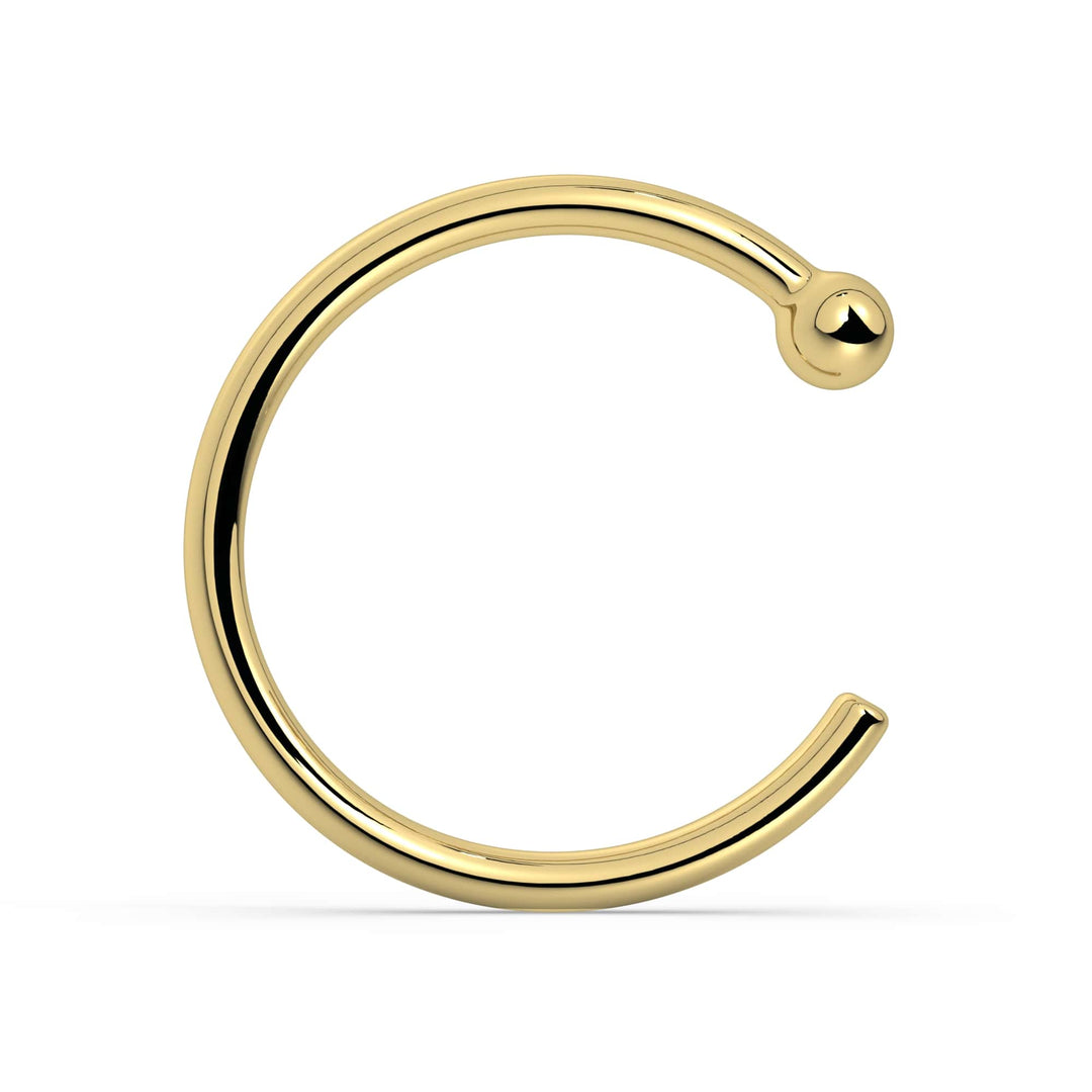 18K yellow gold nose hoop with ball end, polished open-hoop style, front view on white background