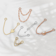 Assorted gold and silver piercing chain connectors styled together showing style variety