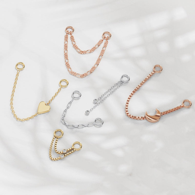 Assorted gold and silver piercing chain connectors styled together showing style variety