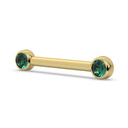 Angled view of 14K yellow gold nipple barbell showing depth of emerald bezel settings