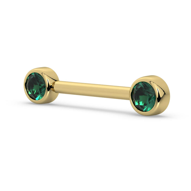 14K yellow gold nipple barbell with dual 4mm emerald bezel settings, angled side view