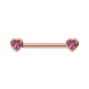 14k rose gold nipple barbell with heart-shaped pink sapphire bezel ends, front view