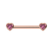 14k rose gold nipple barbell with heart-shaped pink sapphire bezel ends, front view