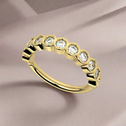 14k yellow gold CZ bubbles seam ring on draped fabric background, angled lifestyle shot