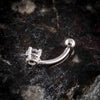 Side profile of 14k white gold diamond navel ring showing curved barbell and prong setting on dark stone surface