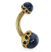 14k yellow gold belly ring with black Akoya pearls in ornate scroll setting, angled side view