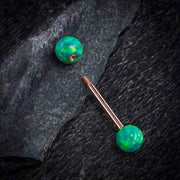14k rose gold teal opal straight barbell disassembled on dark stone, showing internally threaded post