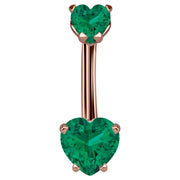 14k rose gold navel ring with dual dark green CZ heart stones in prong settings, front view