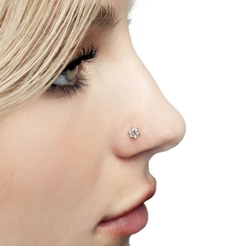14K gold diamond flower pushpin nose stud shown in nostril piercing, model side profile on white background