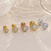 Set of diamond stud earrings in gold and silver on a light background