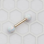 14k yellow gold opal straight barbell resting on hexagon tile surface, lifestyle flat lay