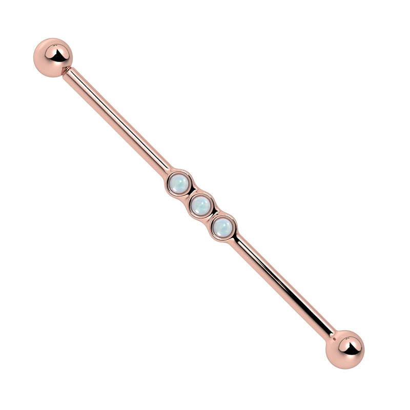 14k rose gold industrial barbell with three bezel-set moonstone cabochons, soft blue-white glow