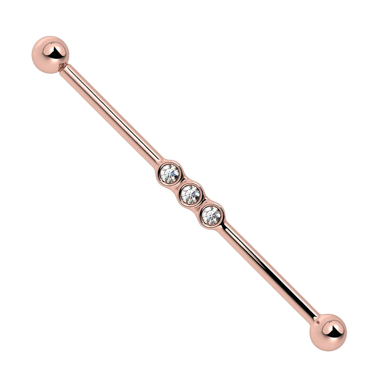 14k rose gold industrial barbell with three bezel-set CZ gems aligned at center, front view