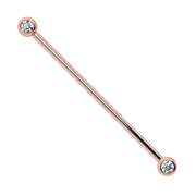 14k rose gold CZ bezel industrial barbell with two round bezel-set stones, front view