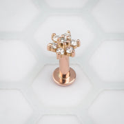 14k rose gold diamond flower flat back labret standing upright, showing flat disc base and post