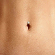 Diamond halo floating belly ring shown in navel piercing on model for fit and scale