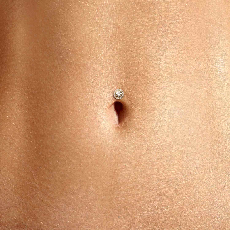 Diamond halo floating belly ring shown in navel piercing on model for fit and scale