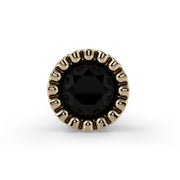 Close-up of 2.5mm black diamond in 14k yellow gold milgrain bezel setting, direct front view